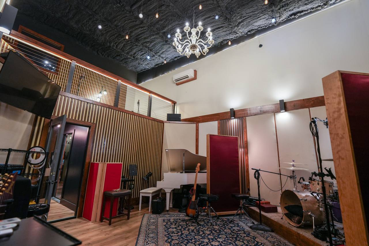 Live Room — chandelier, full band setup, architectural details